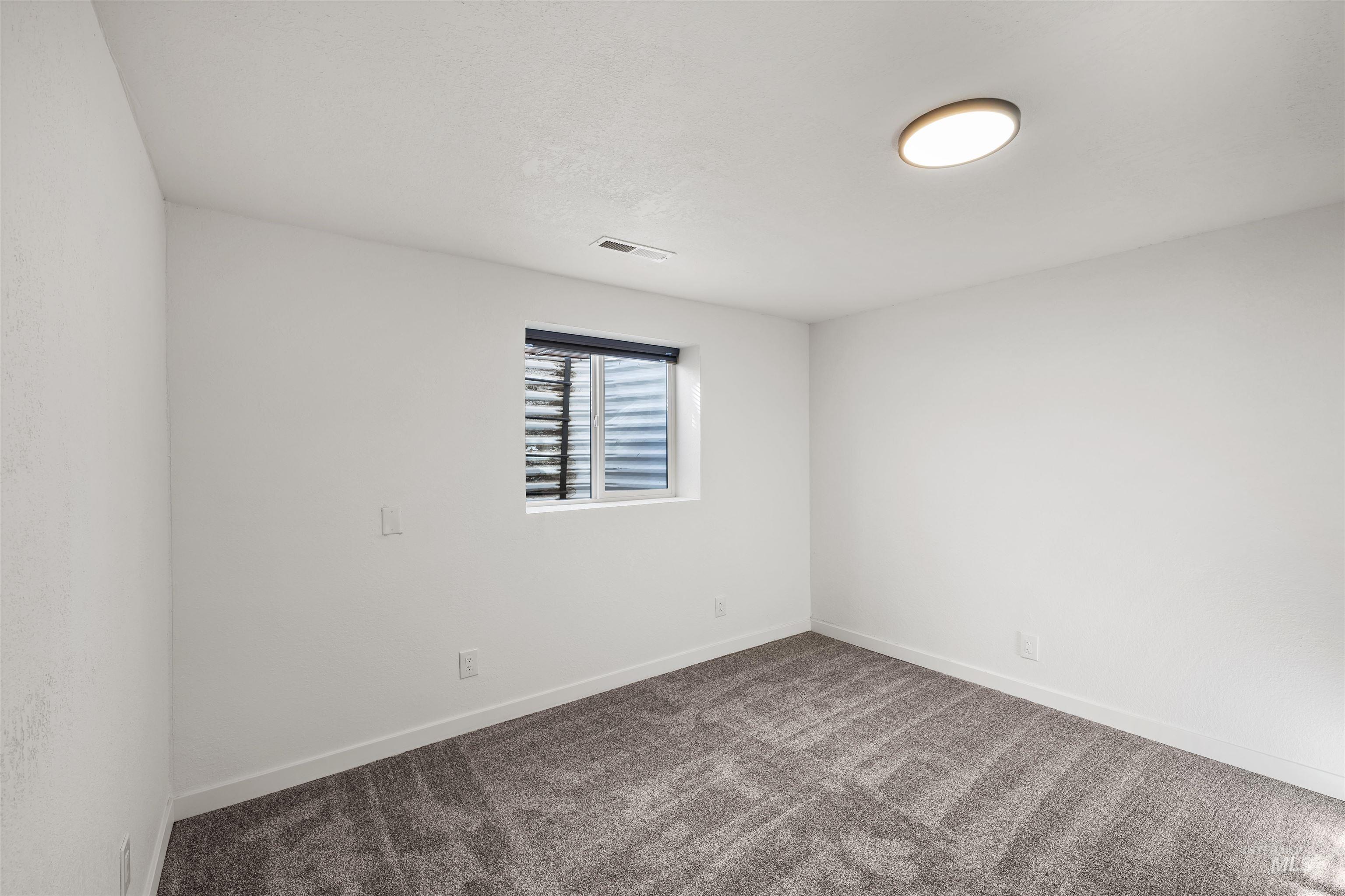 3154 South McCormick Way Boise, ID 83709 - Photo 27 of 50 Spare room featuring carpet floors and baseboards