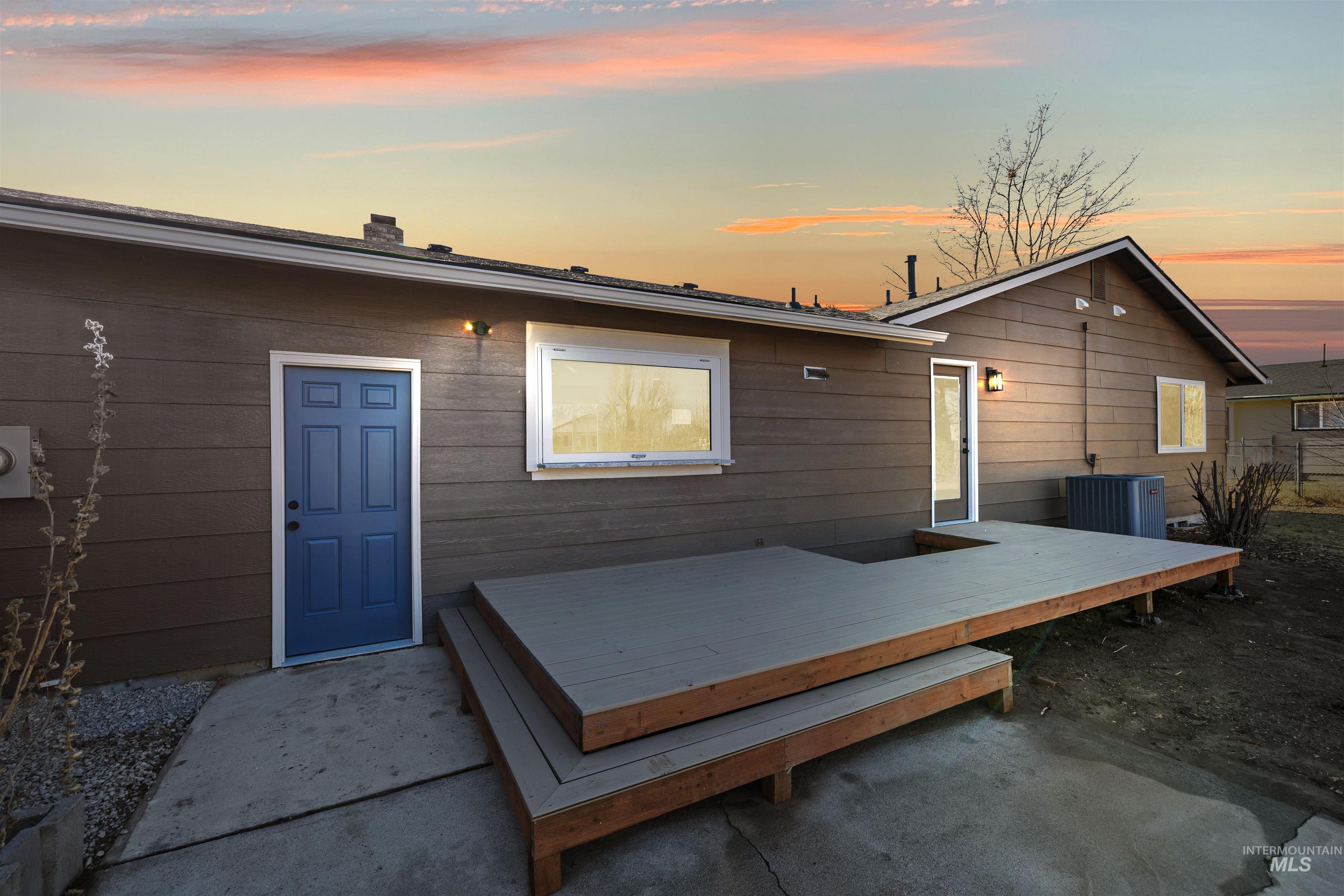 3154 South McCormick Way Boise, ID 83709 - Photo 34 of 50 Back of property at dusk featuring a deck and a chimney