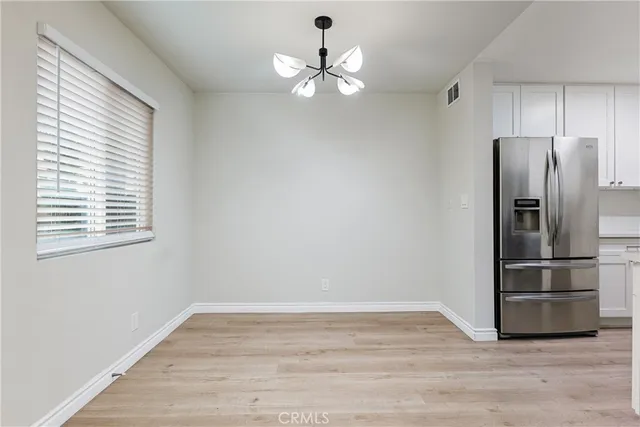 a view of a kitchen with a dishwasher cabinets and a window