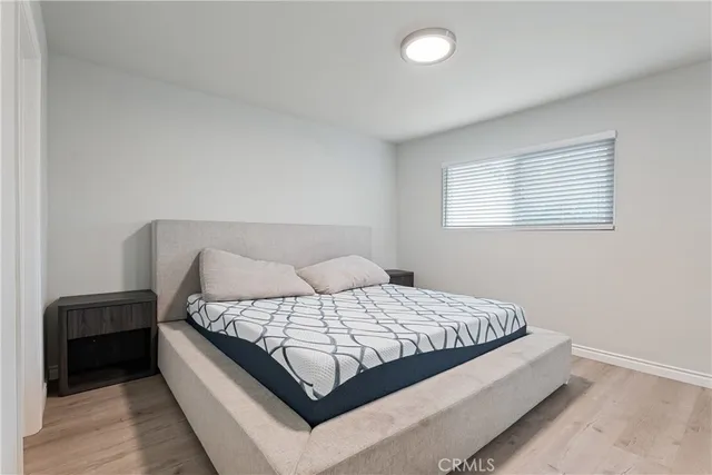 a bedroom with a bed and a lamp