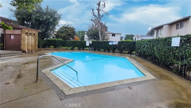 a view of a tennis court with a house