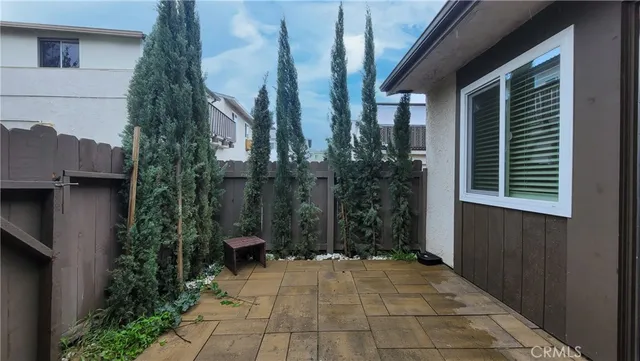 a view of a patio with table and chairs under an umbrella