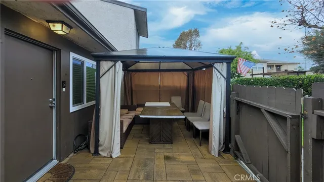 a view of a porch with furniture and front door