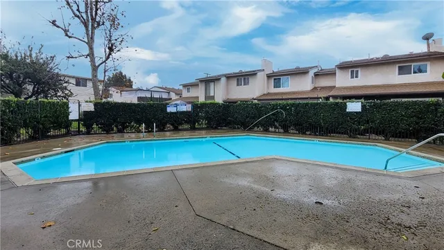 a view of pool with umbrella