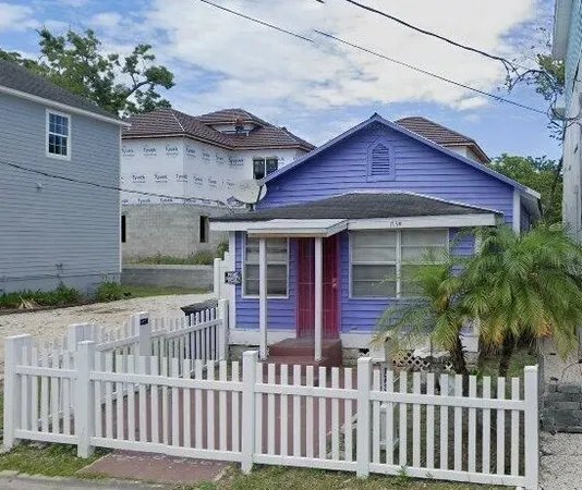a view of a house with a small yard and wooden floor