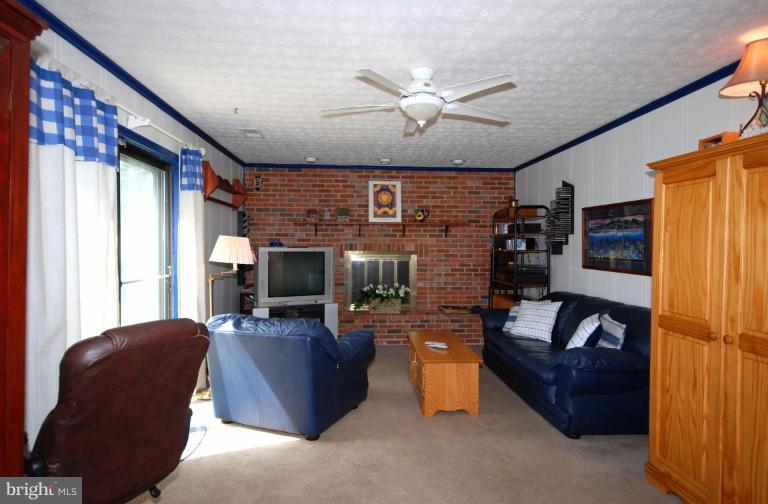 4416 Rendale Court Olney, MD 20832 - Photo 11 of 28 a living room with fireplace furniture and a flat screen tv