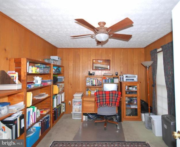 4416 Rendale Court Olney, MD 20832 - Photo 13 of 28 a room with furniture a rug and a book shelf