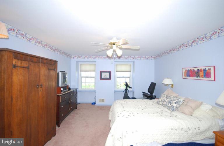 4416 Rendale Court Olney, MD 20832 - Photo 14 of 28 a bedroom with a bed dresser and window