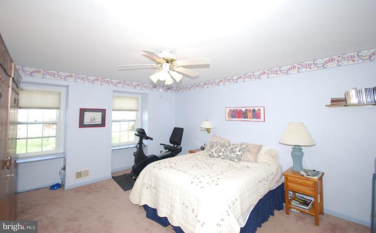 4416 Rendale Court Olney, MD 20832 - Photo 15 of 28 a bedroom with a bed and a chandelier
