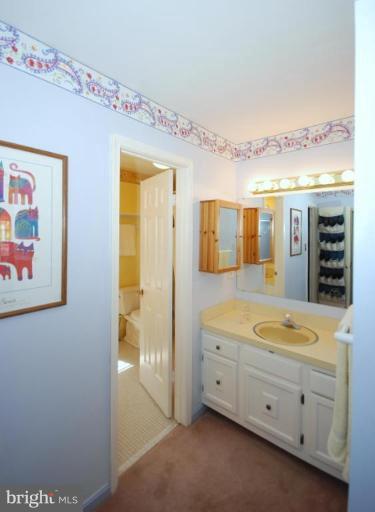 4416 Rendale Court Olney, MD 20832 - Photo 17 of 28 a spacious bathroom with a granite countertop sink mirror and bathtub