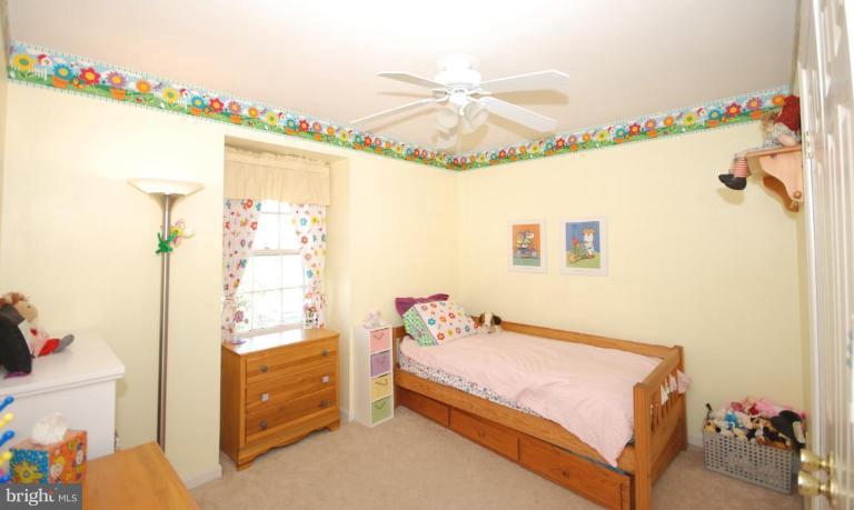 4416 Rendale Court Olney, MD 20832 - Photo 19 of 28 a bedroom with a bed and a chandelier fan