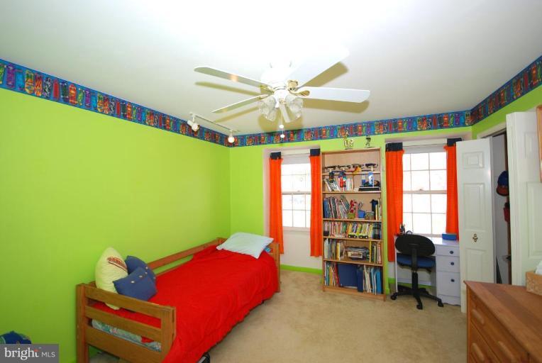 4416 Rendale Court Olney, MD 20832 - Photo 20 of 28 a bedroom with a bed and a bookshelf