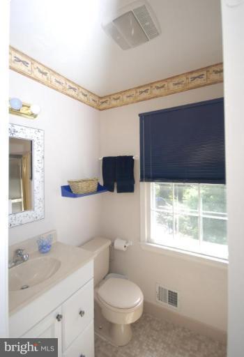 4416 Rendale Court Olney, MD 20832 - Photo 21 of 28 a bathroom with a sink a toilet and a mirror