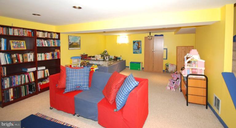 4416 Rendale Court Olney, MD 20832 - Photo 27 of 28 a living room with furniture and a book shelf