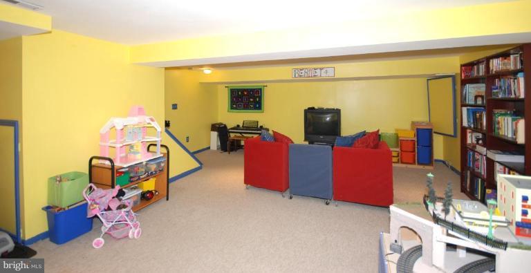 4416 Rendale Court Olney, MD 20832 - Photo 28 of 28 a living room with furniture and a flat screen tv