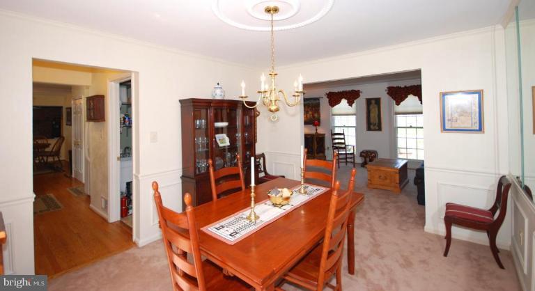 4416 Rendale Court Olney, MD 20832 - Photo 4 of 28 a dining room with furniture a chandelier and wooden floor