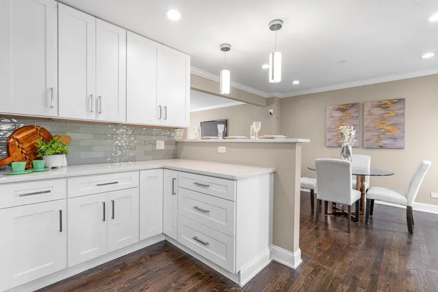 a kitchen with granite countertop white cabinets and white appliances