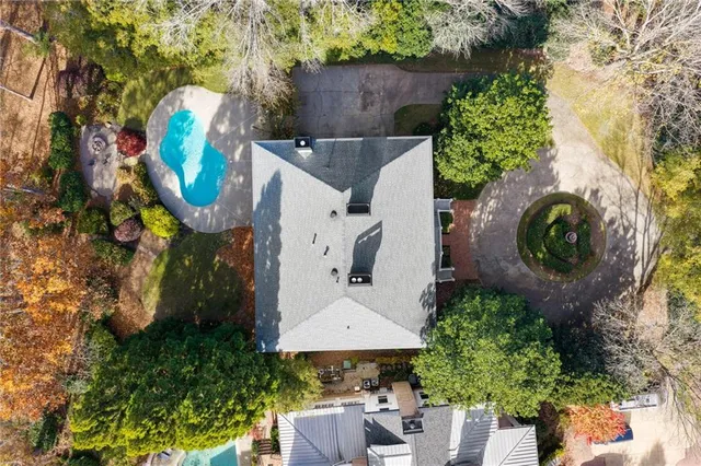 a view of backyard with swimming pool and outdoor seating