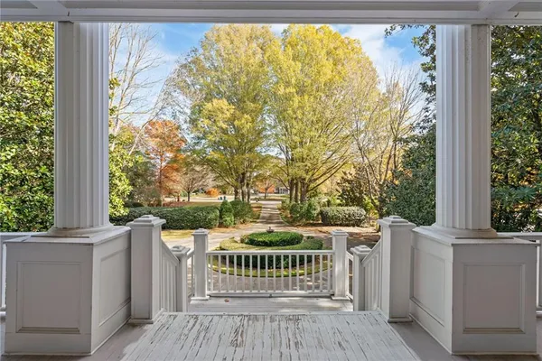 a kitchen with stainless steel appliances a stove top oven a refrigerator a sink and white cabinets with wooden floor