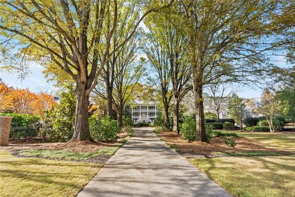 a view of a room with wooden floor lounge chair and windows