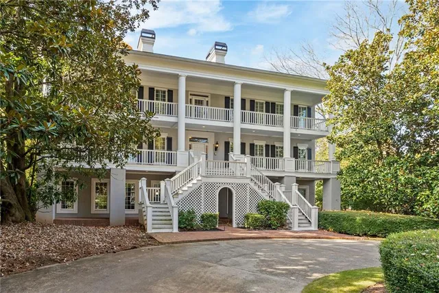 a bathroom with a granite countertop sink and a large mirror