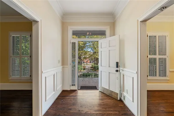 an empty room with a ceiling fan and windows