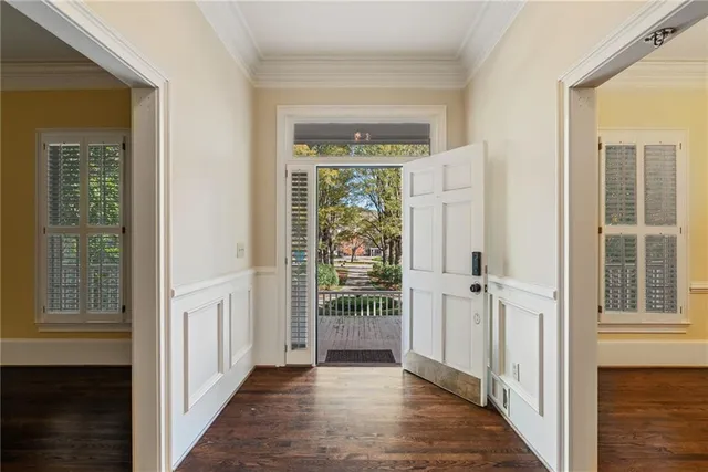 an empty room with a ceiling fan and windows