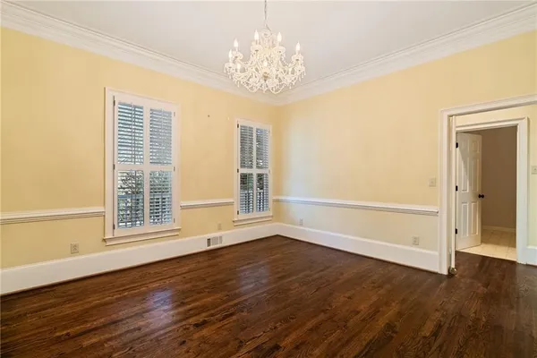 an empty room with a ceiling fan and a window