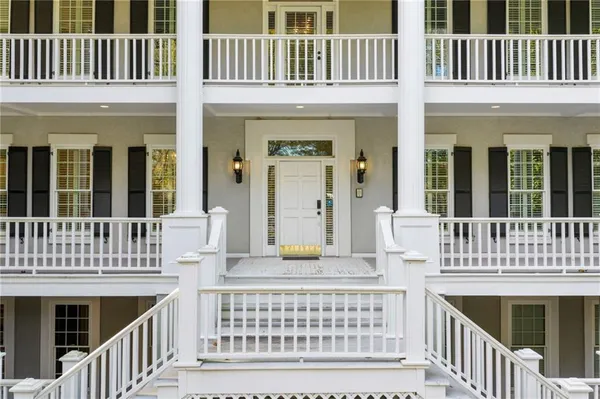 front view of a brick house with a yard