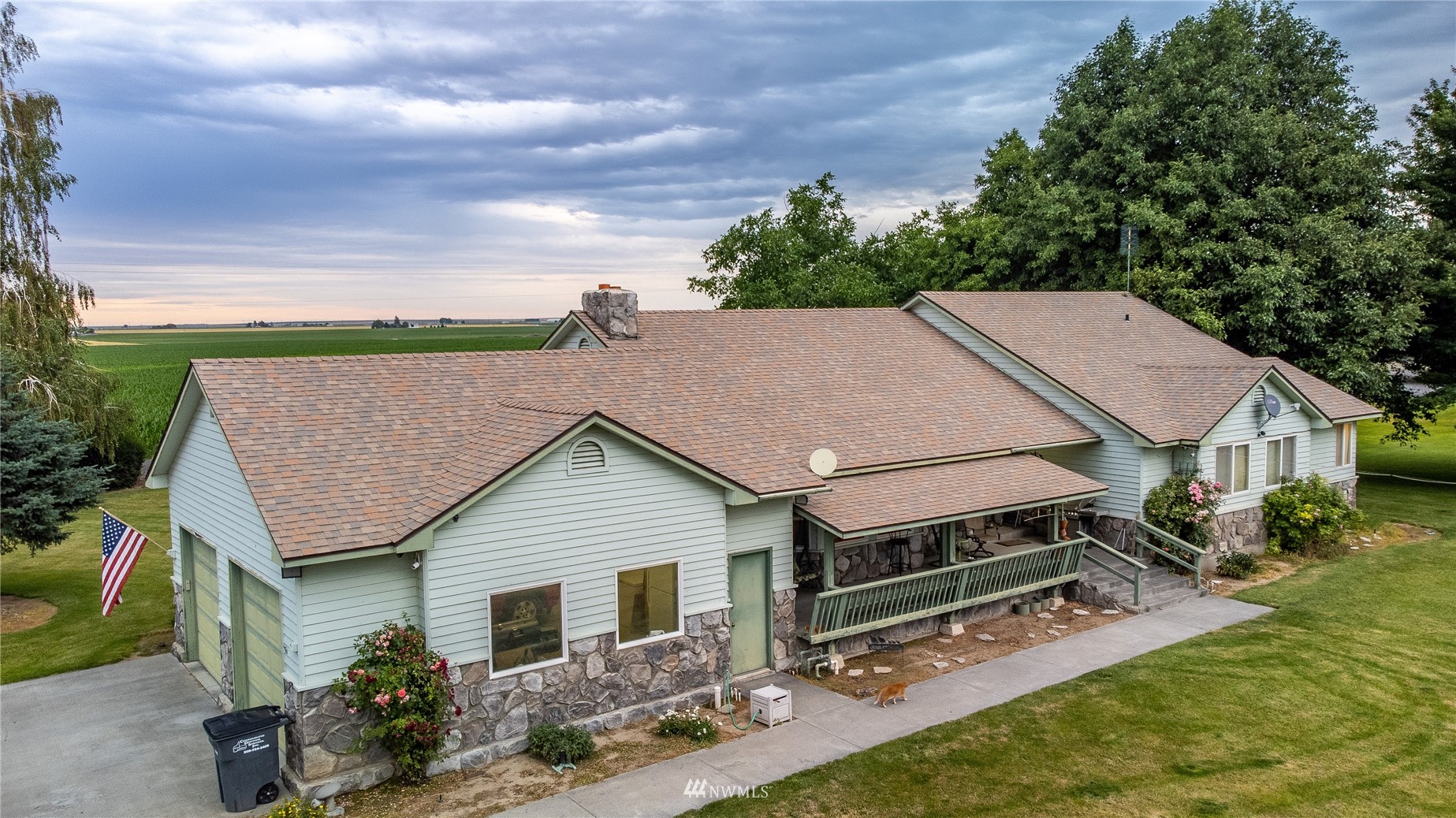 1659 West Gillis Road Othello, WA 99344 - Photo 1 of 38 a aerial view of a house with a yard and potted plants