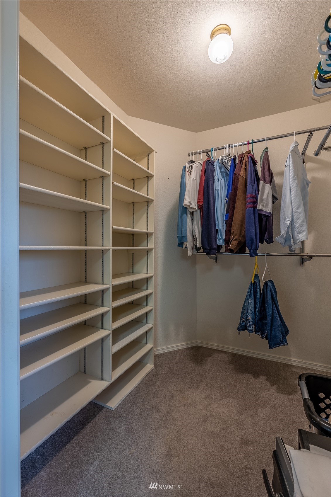 1659 West Gillis Road Othello, WA 99344 - Photo 19 of 38 a view of walk in closet with clothes and shoes