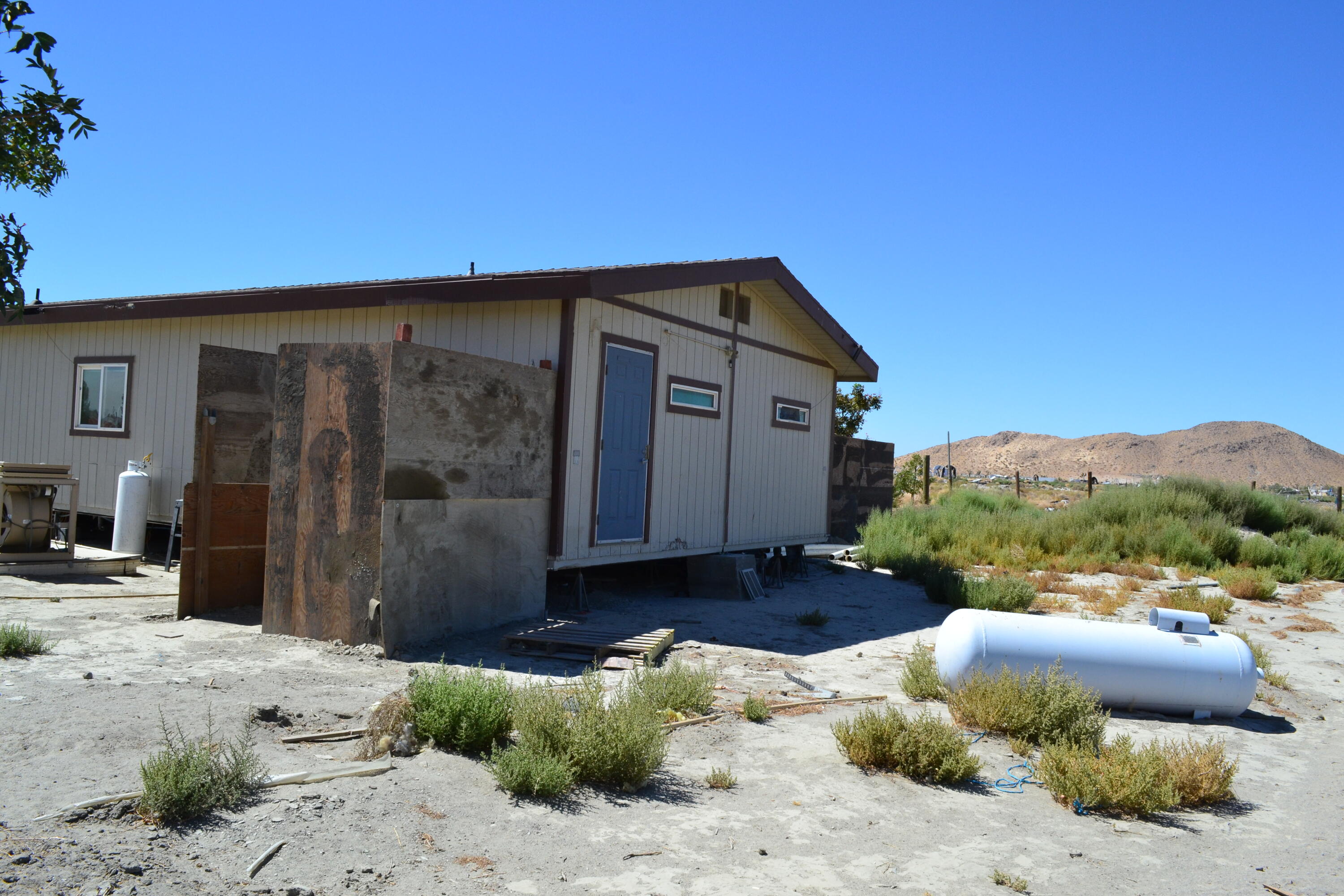 20025 Chamisal Street Adelanto, CA 92301 - Photo 6 of 46 a front view of a house with a yard