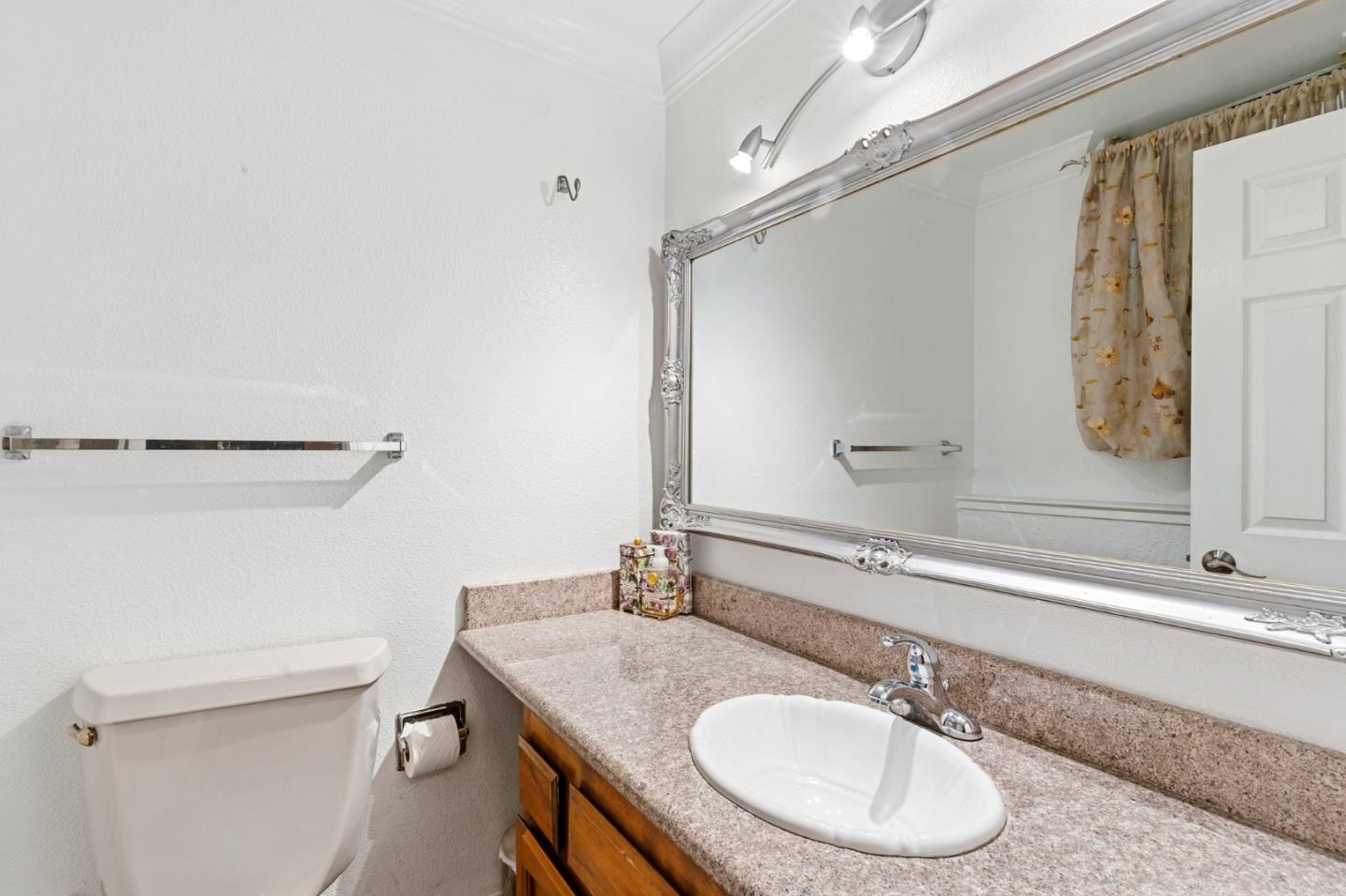 1743 Panda Way Hayward, CA 94541 - Photo 21 of 34 a bathroom with a granite countertop sink toilet and a mirror