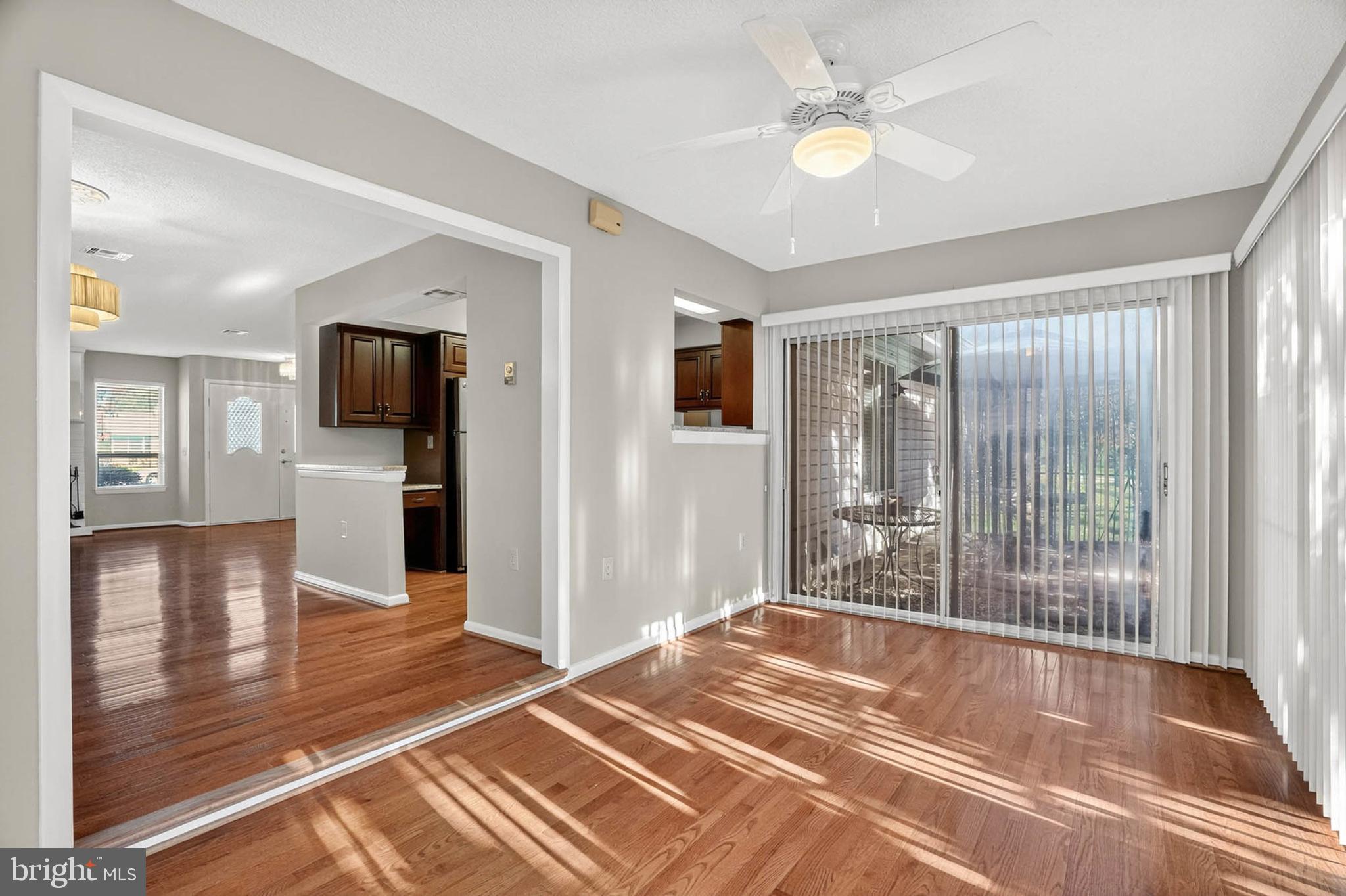 3416 Island Creek Court, Unit 127C Silver Spring, MD 20906 - Photo 11 of 60 a view of a livingroom with wooden floor and a ceiling fan