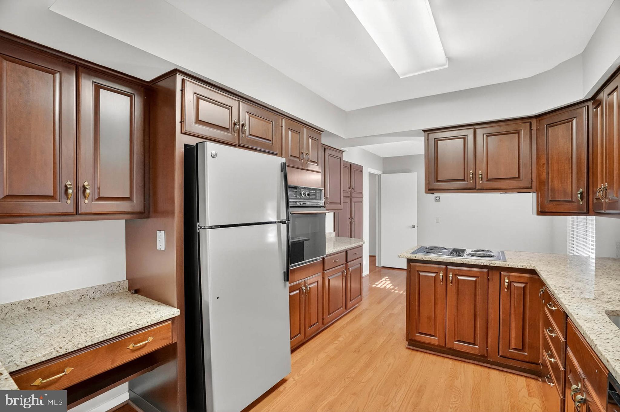 3416 Island Creek Court, Unit 127C Silver Spring, MD 20906 - Photo 12 of 60 a kitchen with stainless steel appliances granite countertop a refrigerator and a sink