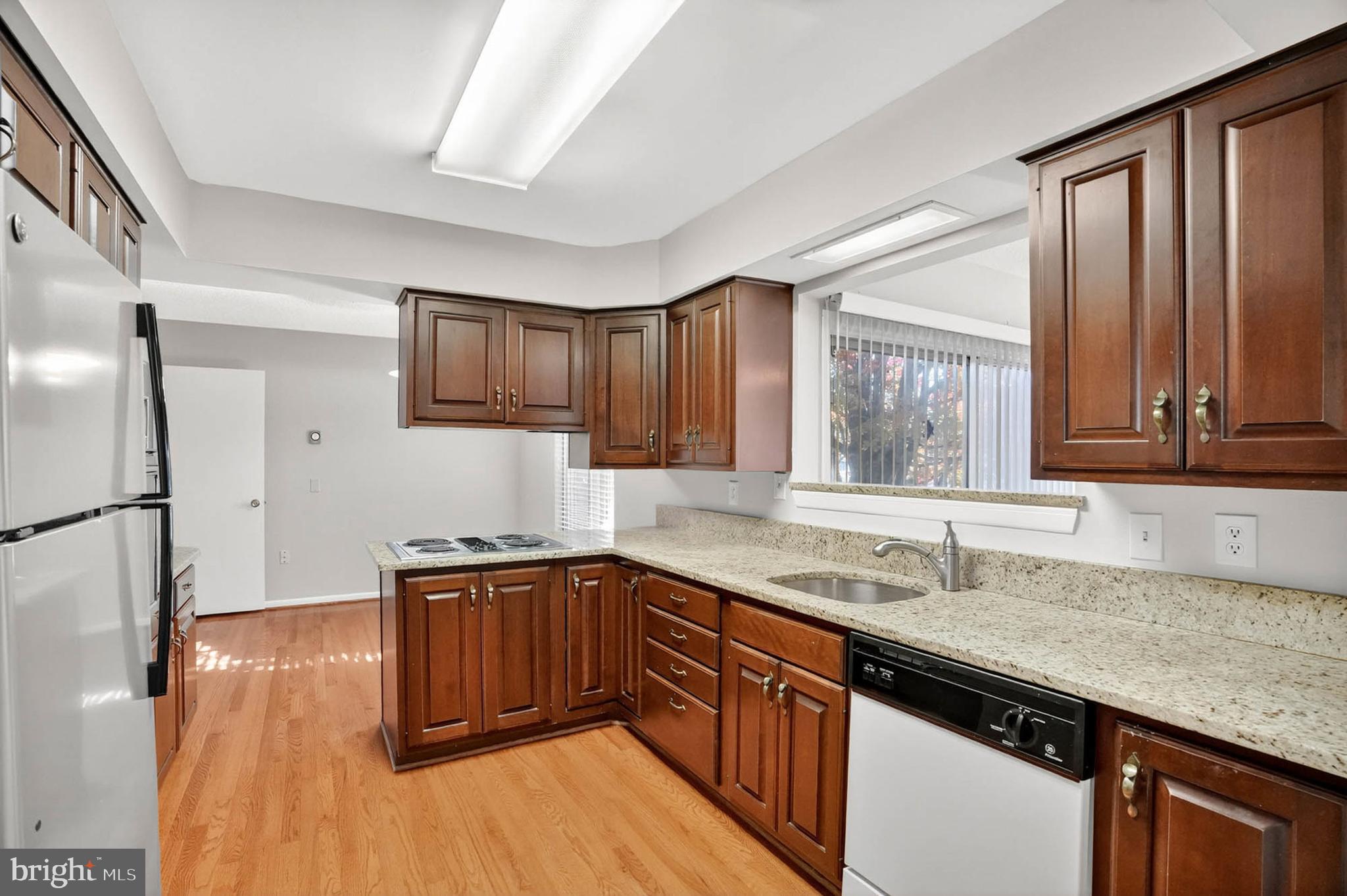 3416 Island Creek Court, Unit 127C Silver Spring, MD 20906 - Photo 13 of 60 a kitchen with stainless steel appliances granite countertop a sink stove and refrigerator