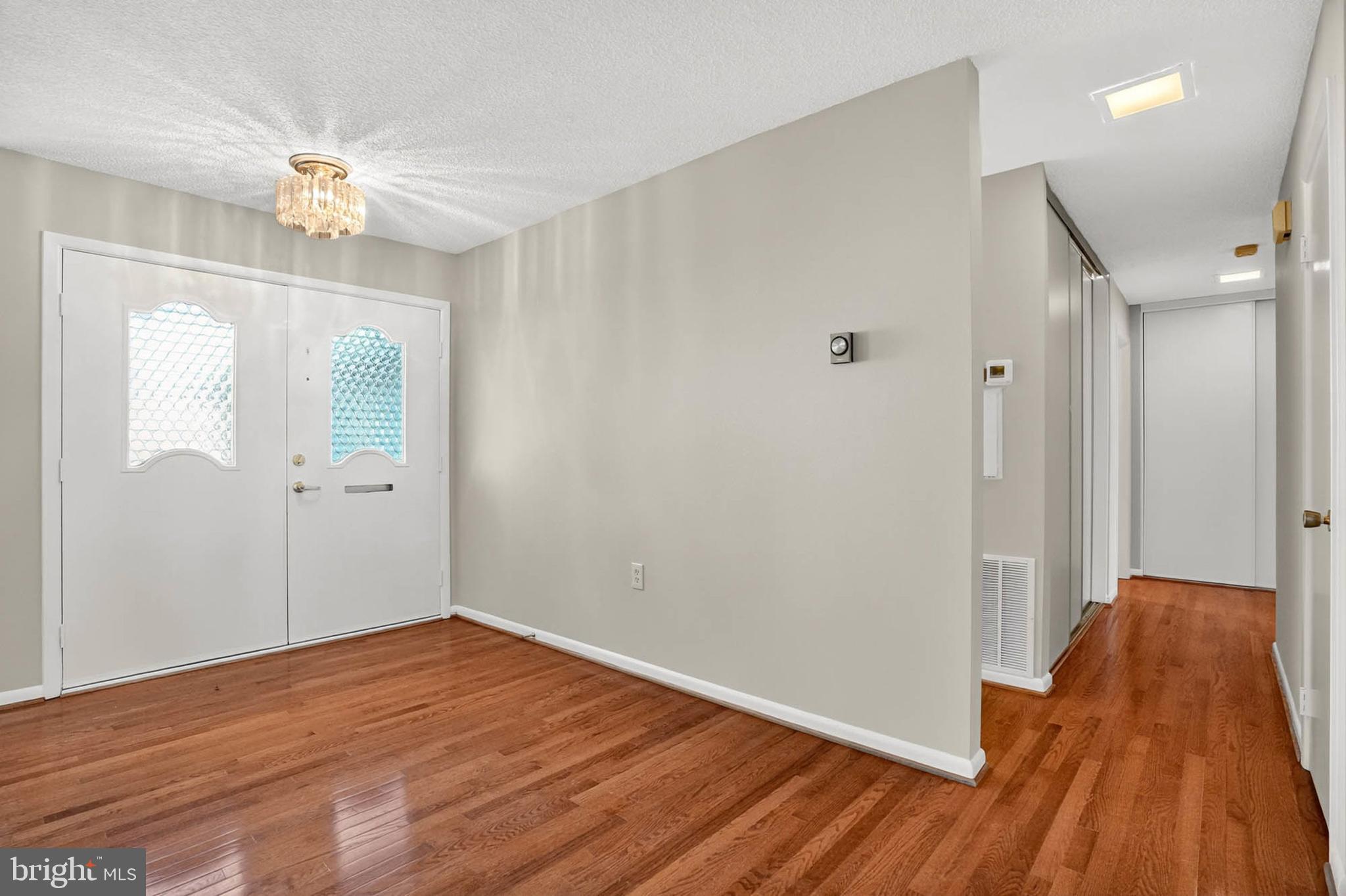 3416 Island Creek Court, Unit 127C Silver Spring, MD 20906 - Photo 3 of 60 wooden floor in an empty room with a window
