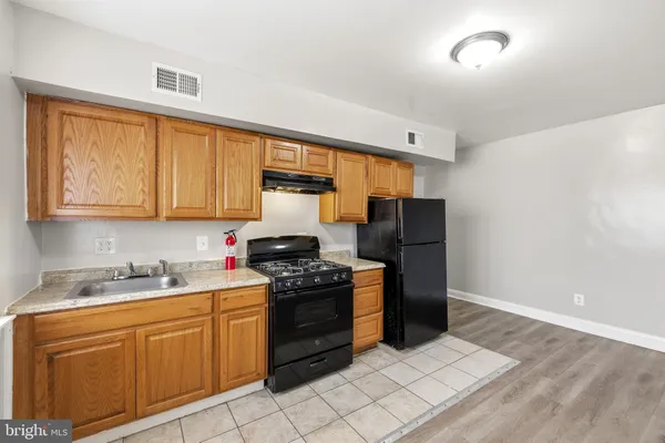 a kitchen with stainless steel appliances a stove sink and refrigerator