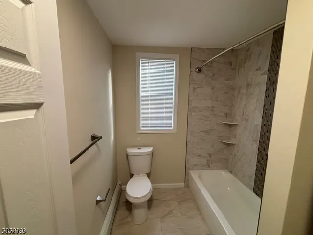 a bathroom with a toilet a sink and shower