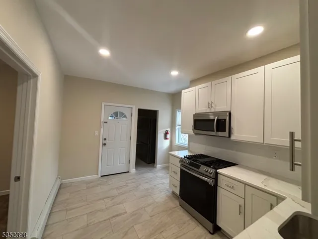 a kitchen with a sink and a stove top oven