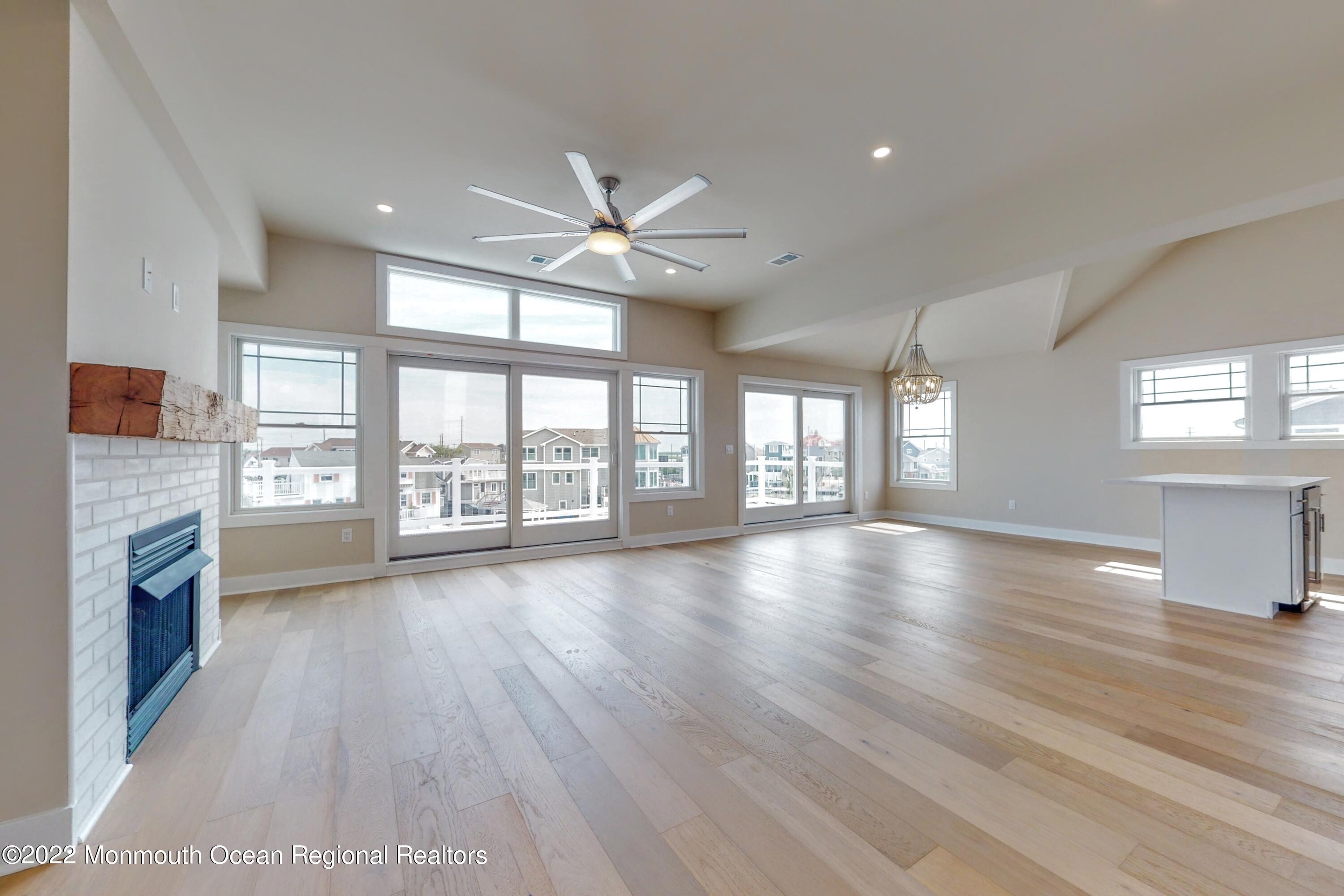 48 Muriel Drive Manahawkin, NJ 08050 - Photo 11 of 89 a view of an empty room with a window and wooden floor