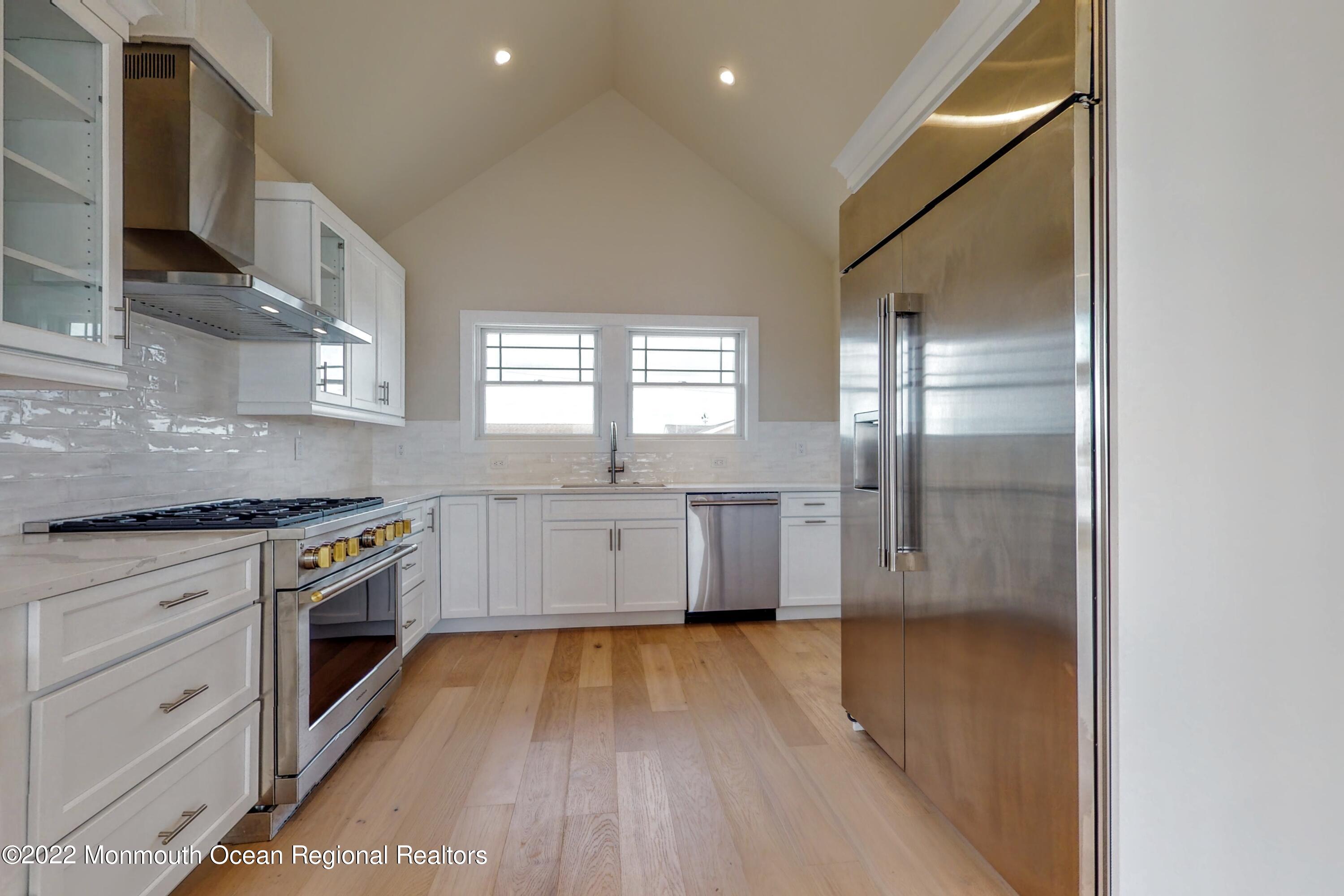 48 Muriel Drive Manahawkin, NJ 08050 - Photo 20 of 89 a kitchen with stainless steel appliances granite countertop a stove a sink and a refrigerator