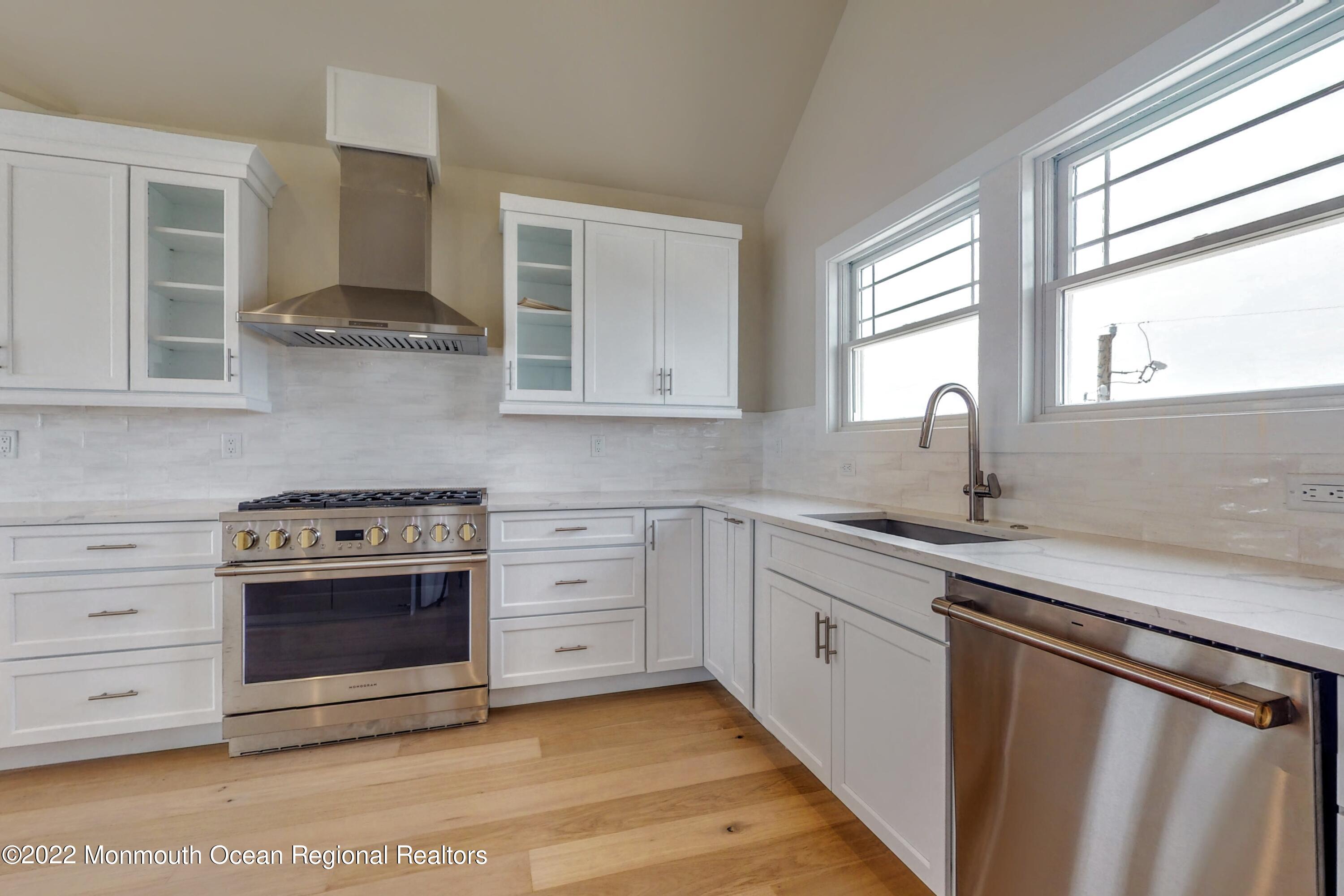 48 Muriel Drive Manahawkin, NJ 08050 - Photo 23 of 89 a kitchen with stainless steel appliances granite countertop a sink stove and cabinets