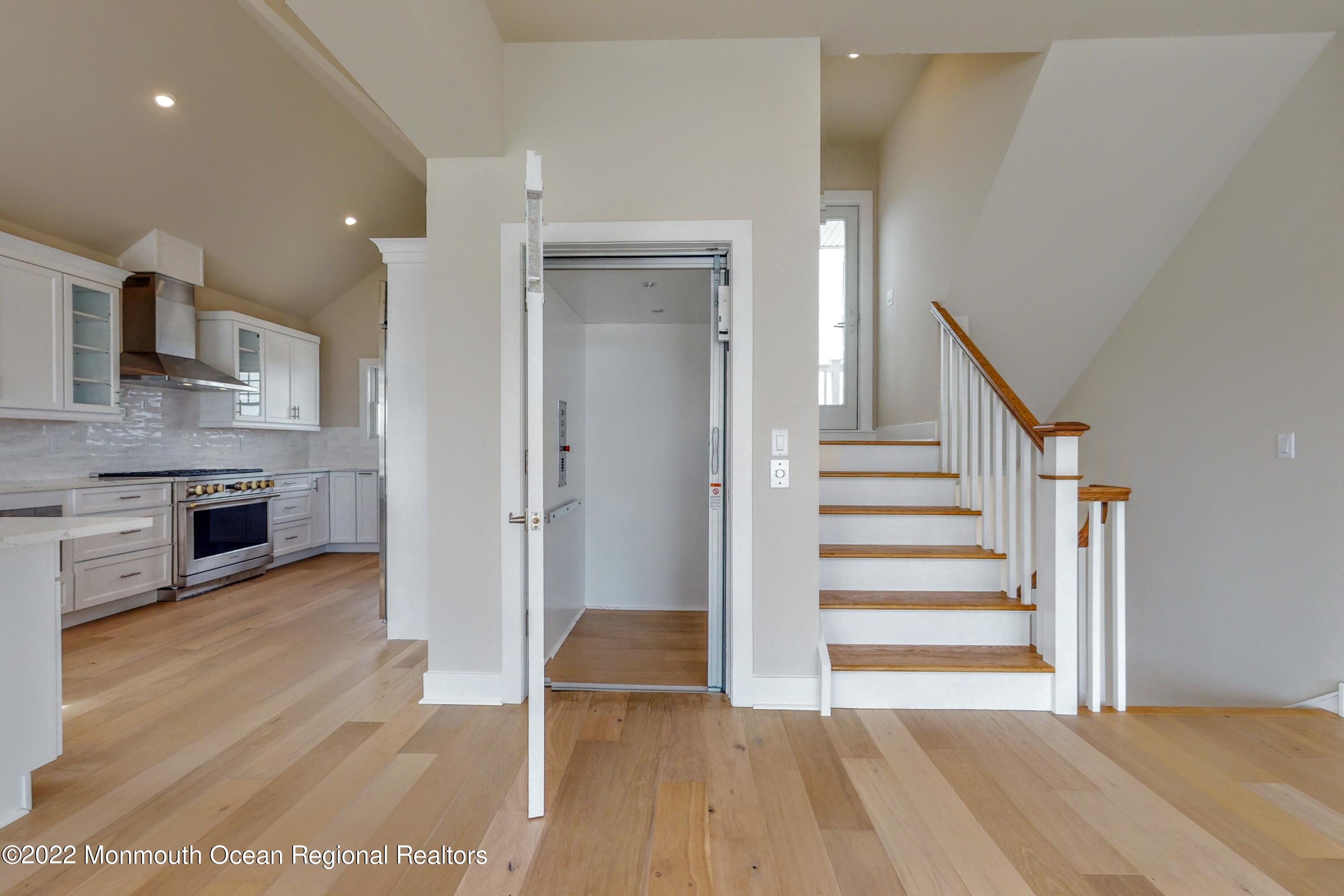 48 Muriel Drive Manahawkin, NJ 08050 - Photo 25 of 89 a view of a hallway with wooden floor and a fireplace