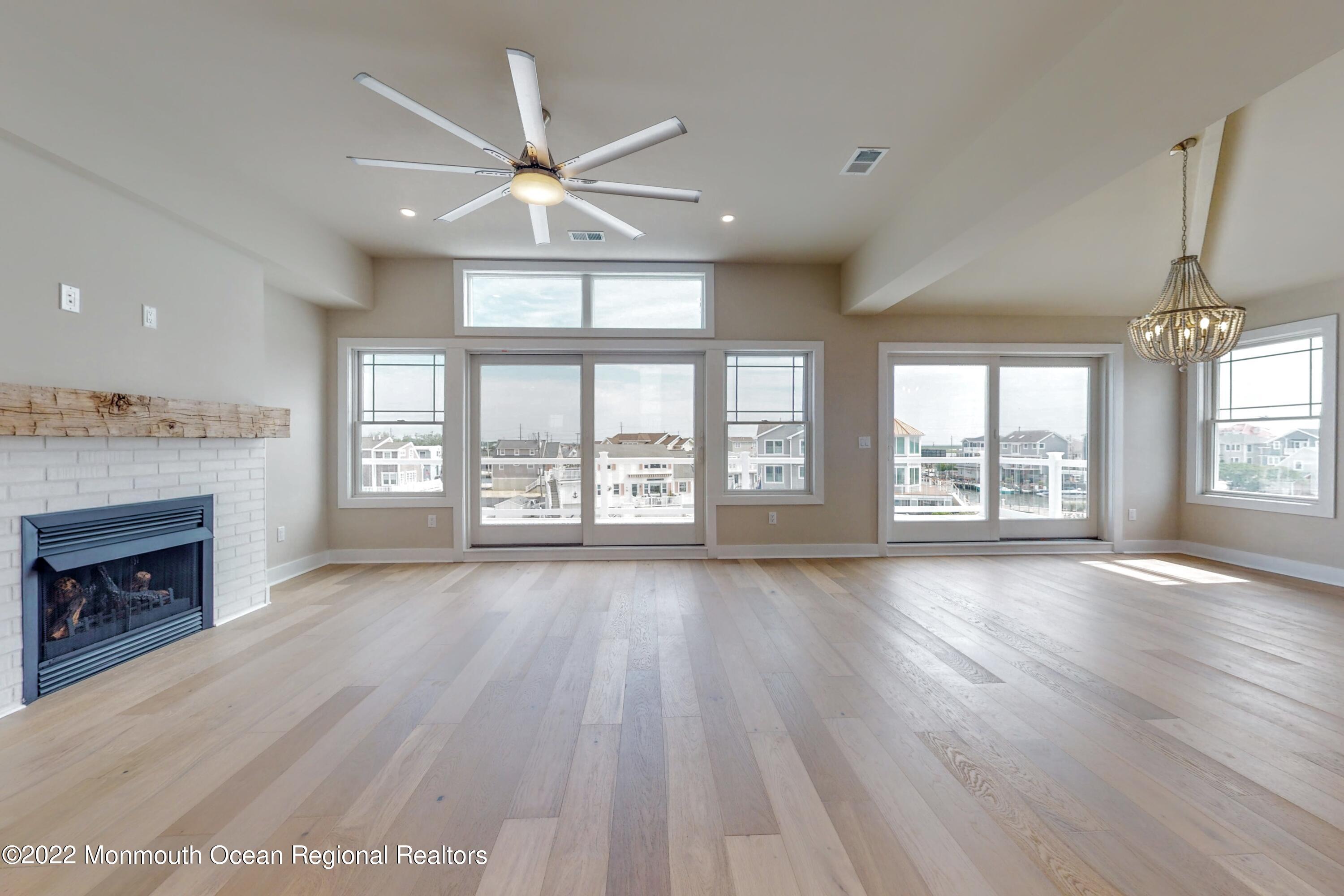 48 Muriel Drive Manahawkin, NJ 08050 - Photo 28 of 89 an empty room with wooden floor fan and windows