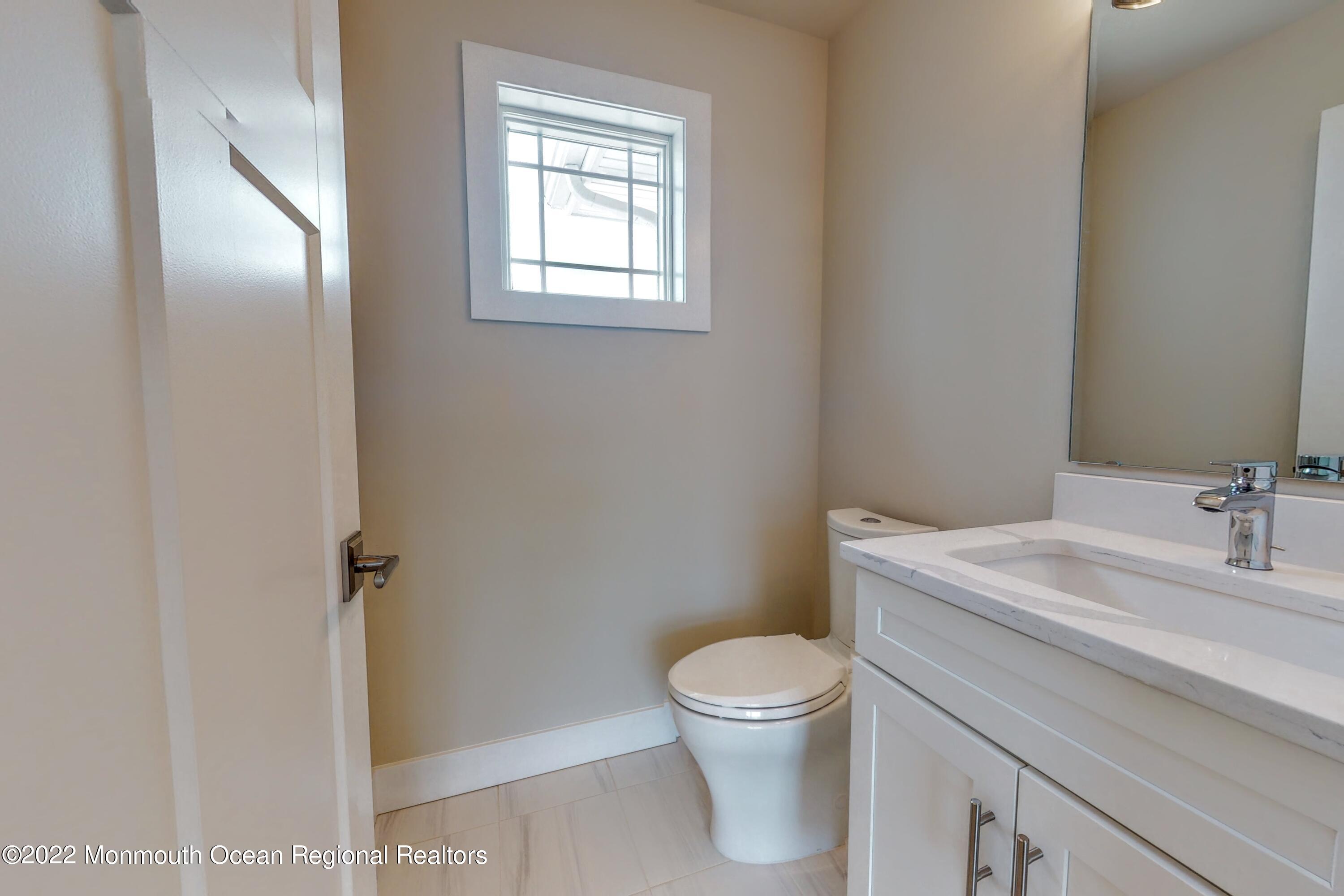 48 Muriel Drive Manahawkin, NJ 08050 - Photo 29 of 89 a white toilet sitting next to a bathroom sink