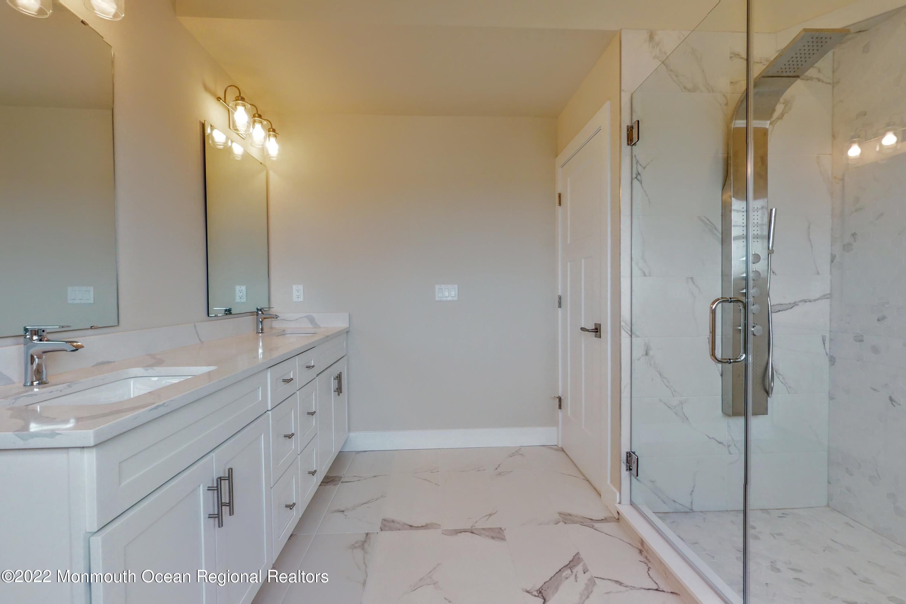 48 Muriel Drive Manahawkin, NJ 08050 - Photo 32 of 89 a bathroom with a double vanity sink mirror and shower