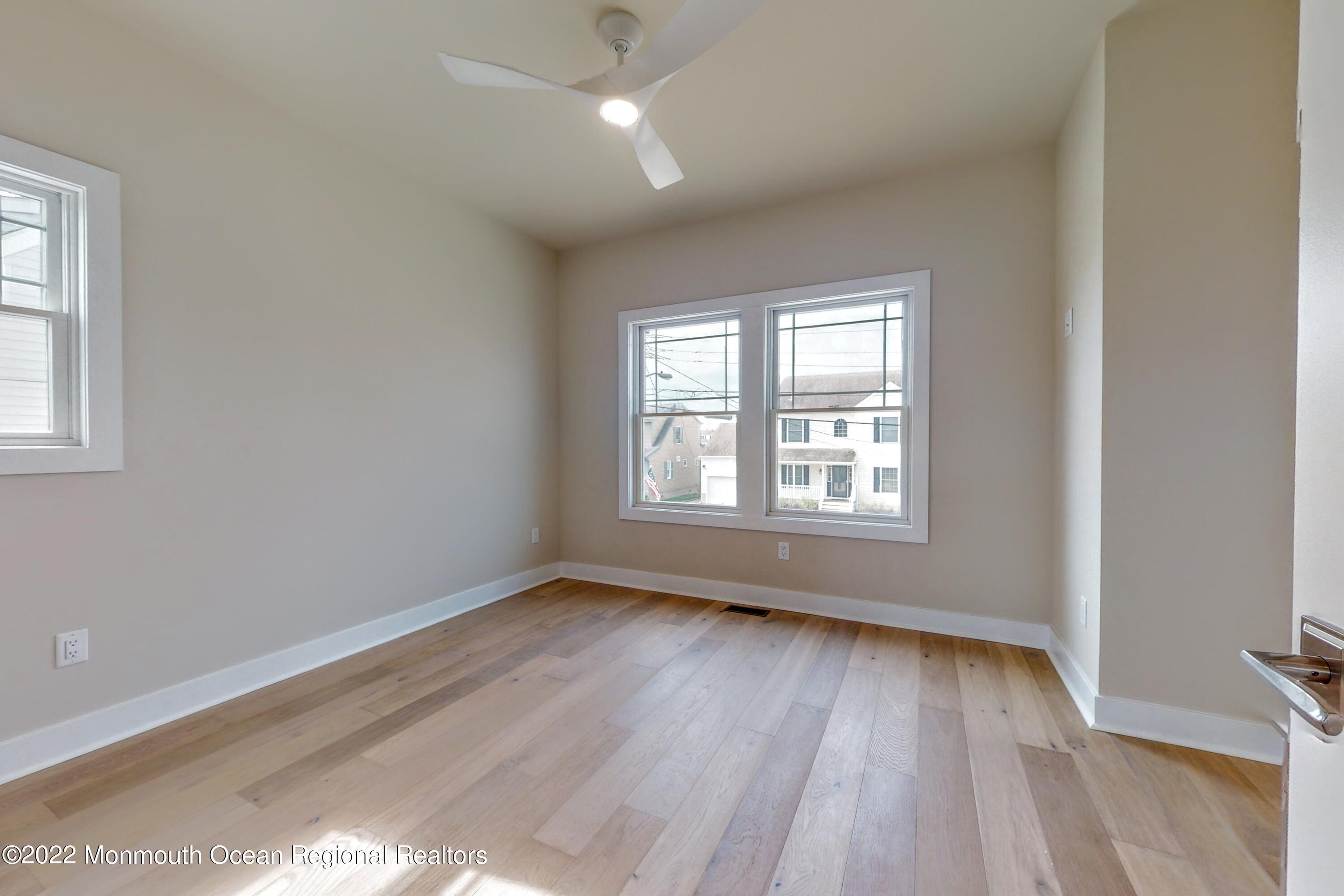 48 Muriel Drive Manahawkin, NJ 08050 - Photo 49 of 89 a view of an empty room with wooden floor and a window