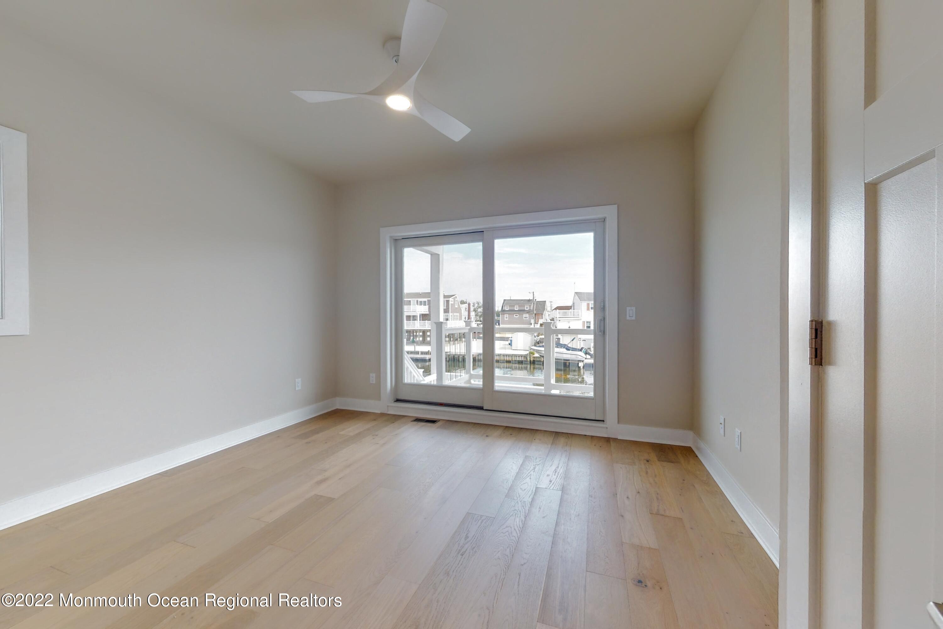 48 Muriel Drive Manahawkin, NJ 08050 - Photo 50 of 89 an empty room with wooden floor and windows