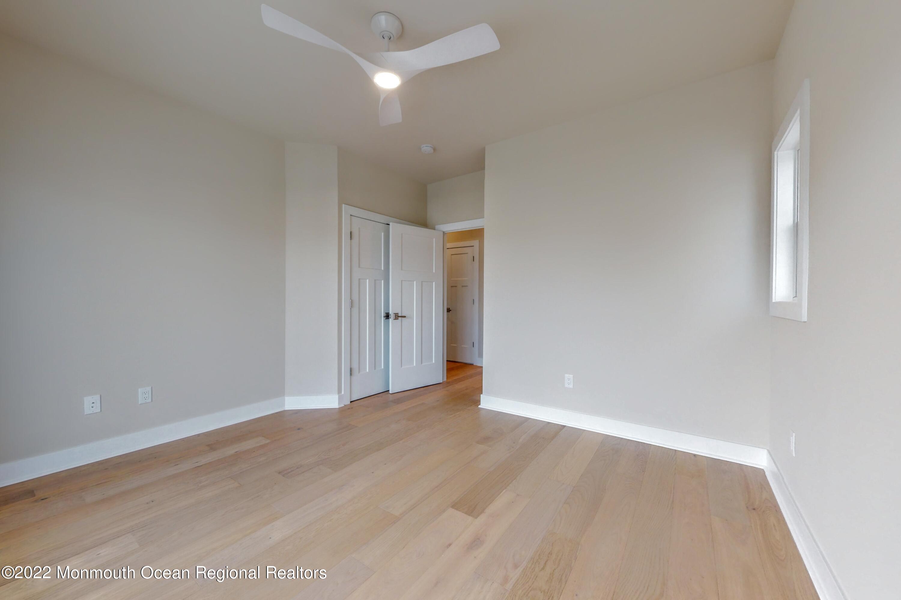 48 Muriel Drive Manahawkin, NJ 08050 - Photo 51 of 89 an empty room with wooden floor and windows